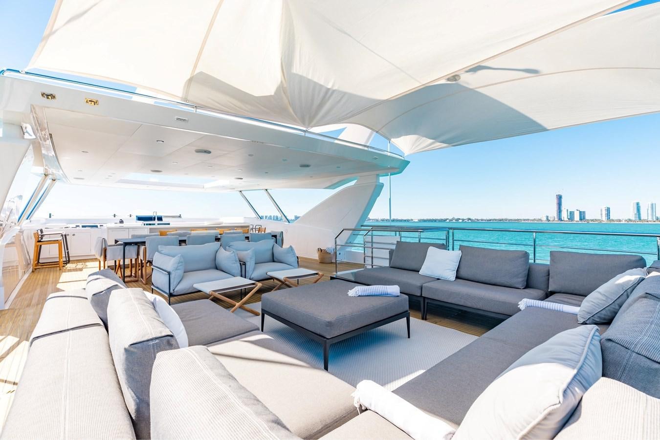 a large lounge area with a large lounge chair and a large blue ocean aboard ADAGIO Yacht for Sale