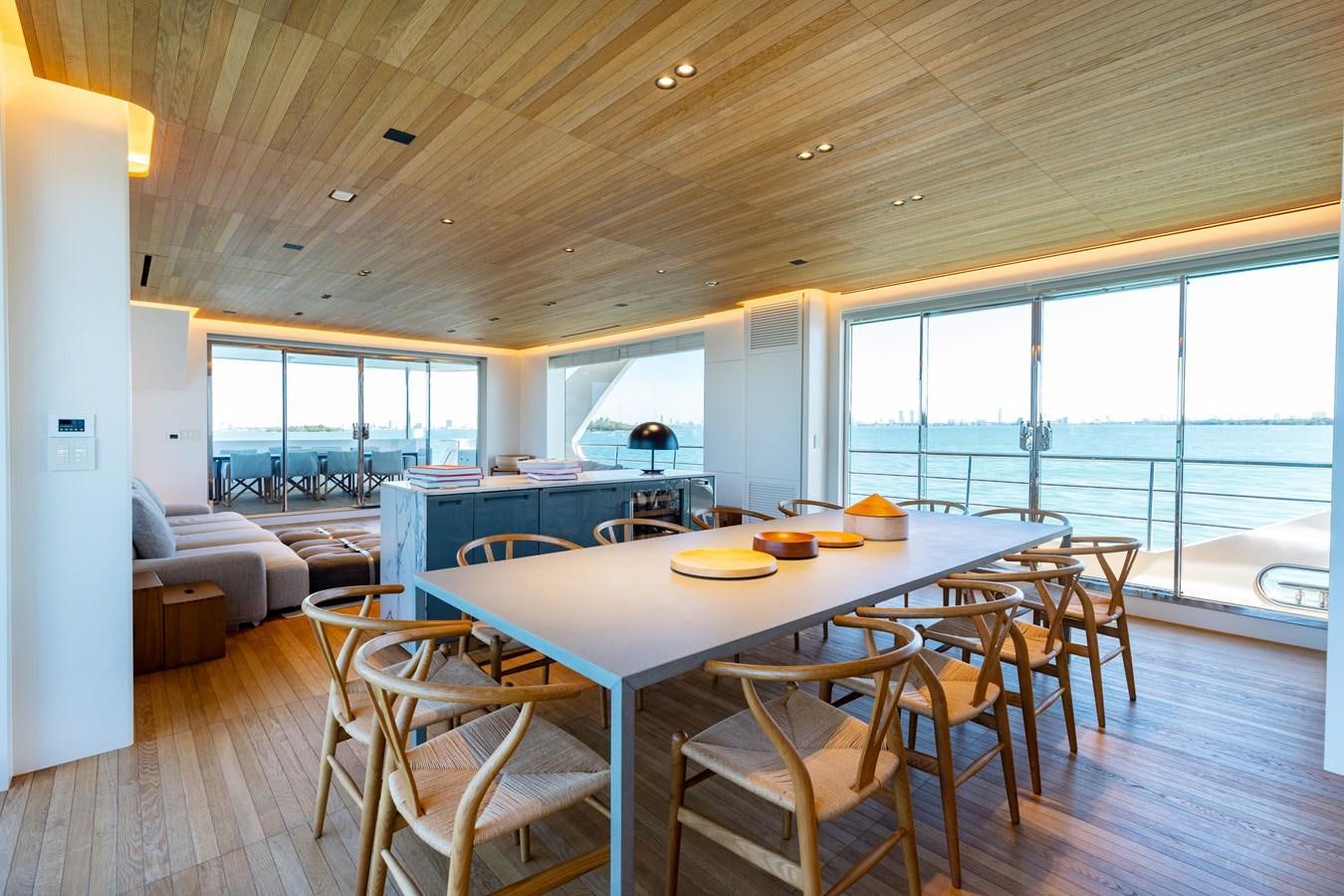 a large dining table in a living room aboard ADAGIO Yacht for Sale