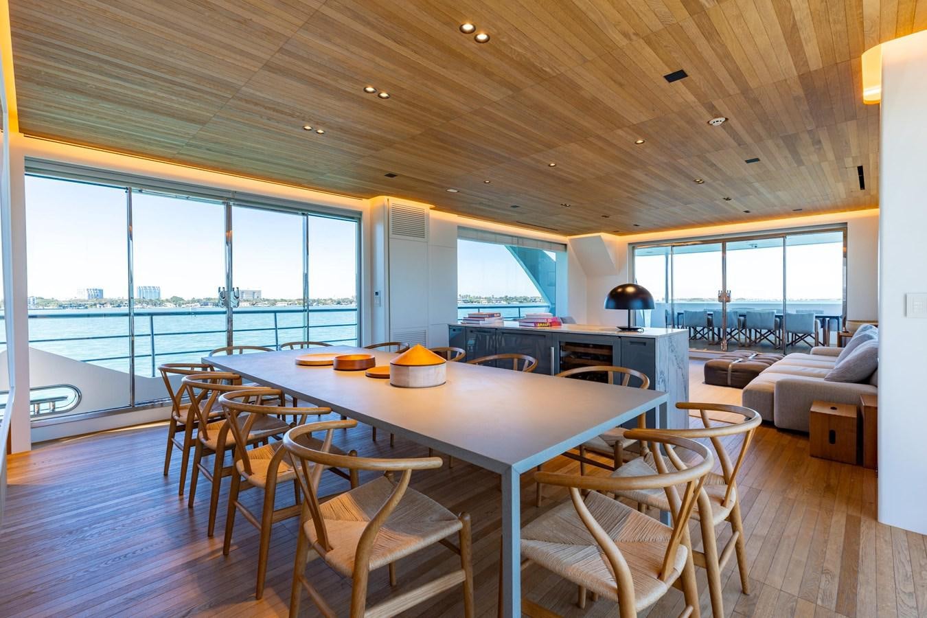 a large dining table in a living room aboard ADAGIO Yacht for Sale