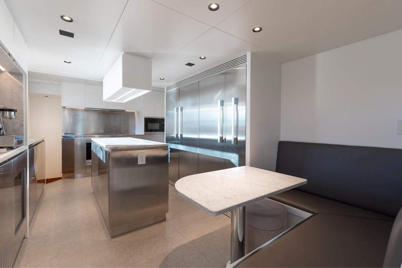 a room with a table and a couch aboard ADAGIO Yacht for Sale