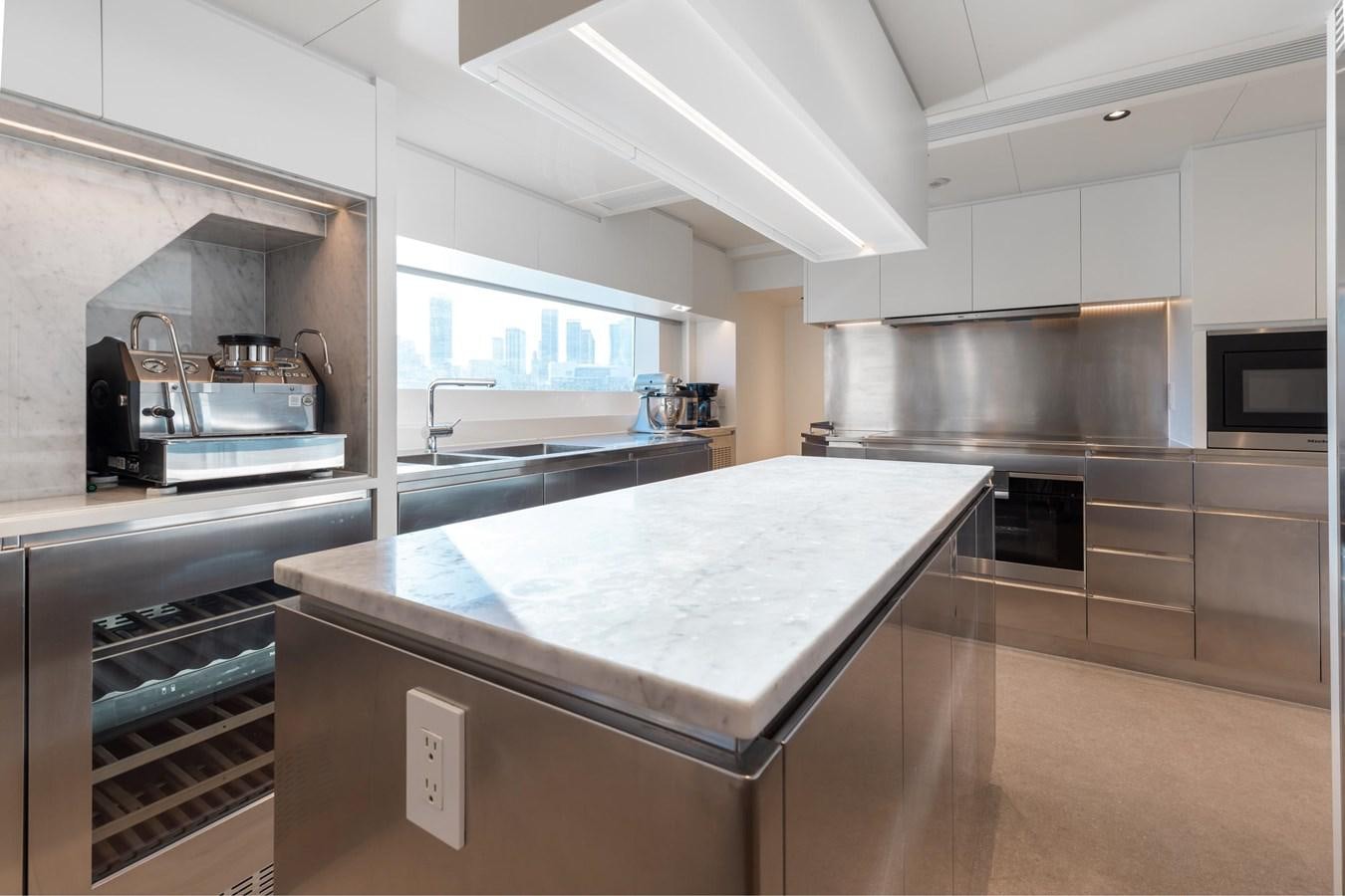 a kitchen with a large island aboard ADAGIO Yacht for Sale