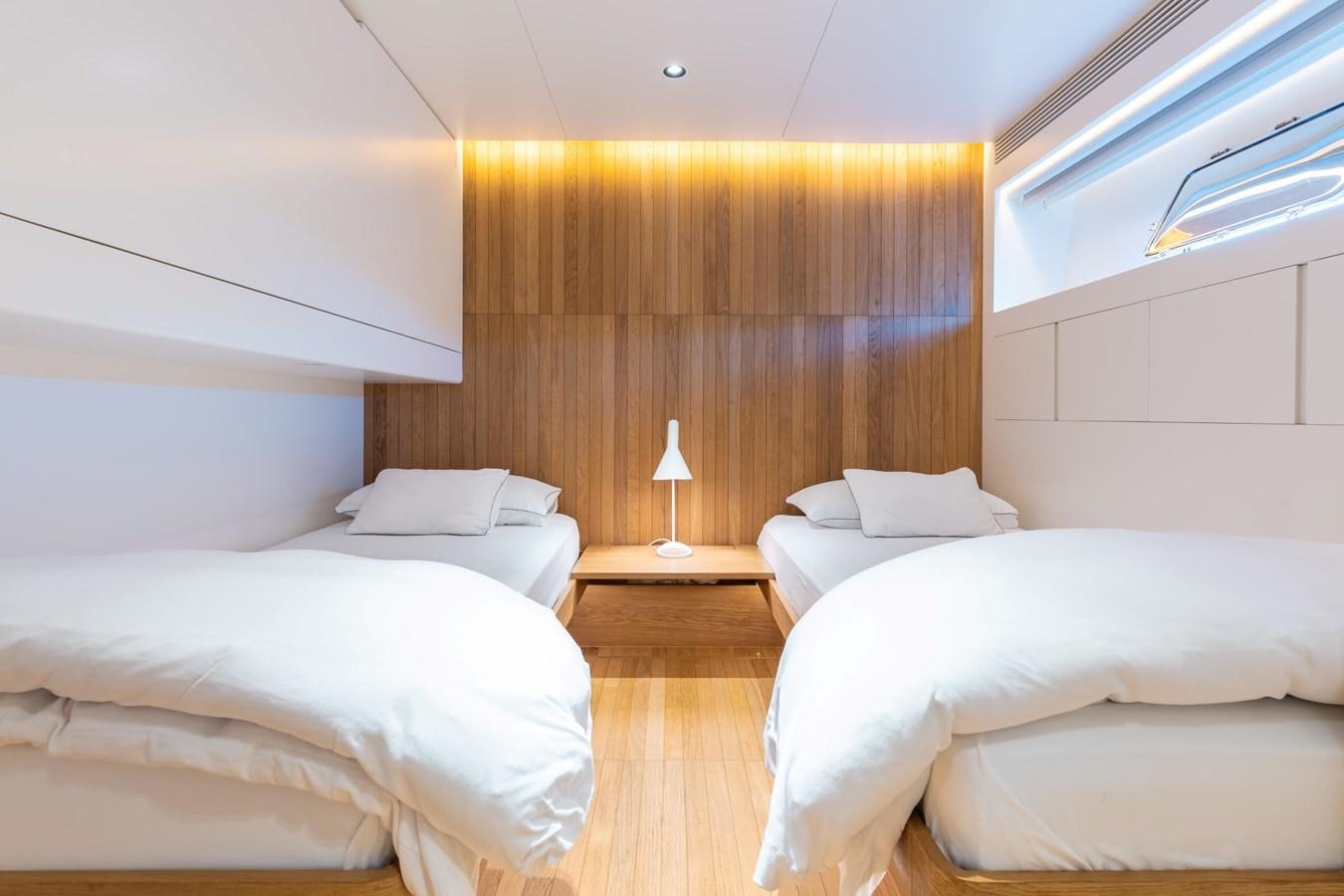 a room with a couple of beds aboard ADAGIO Yacht for Sale