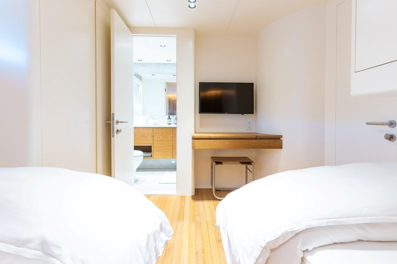 a room with a bed and a television aboard ADAGIO Yacht for Sale