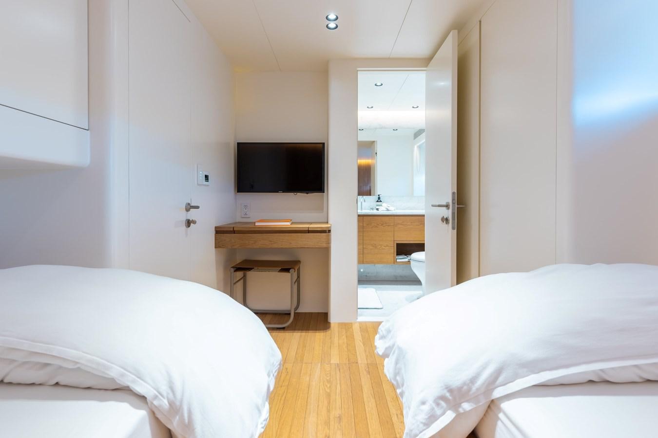 a room with a bed and a desk aboard ADAGIO Yacht for Sale