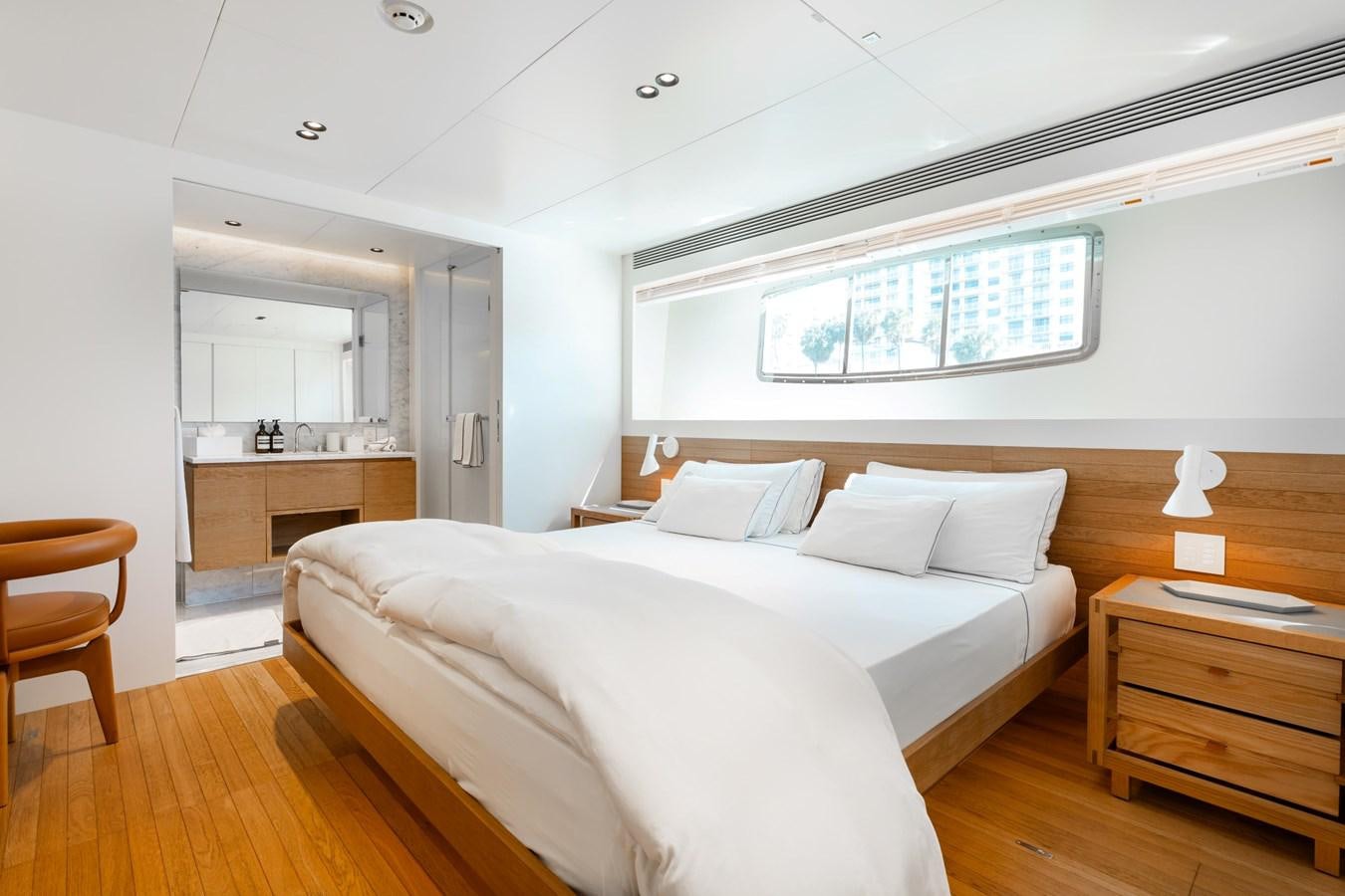 a bedroom with a bed and a desk aboard ADAGIO Yacht for Sale