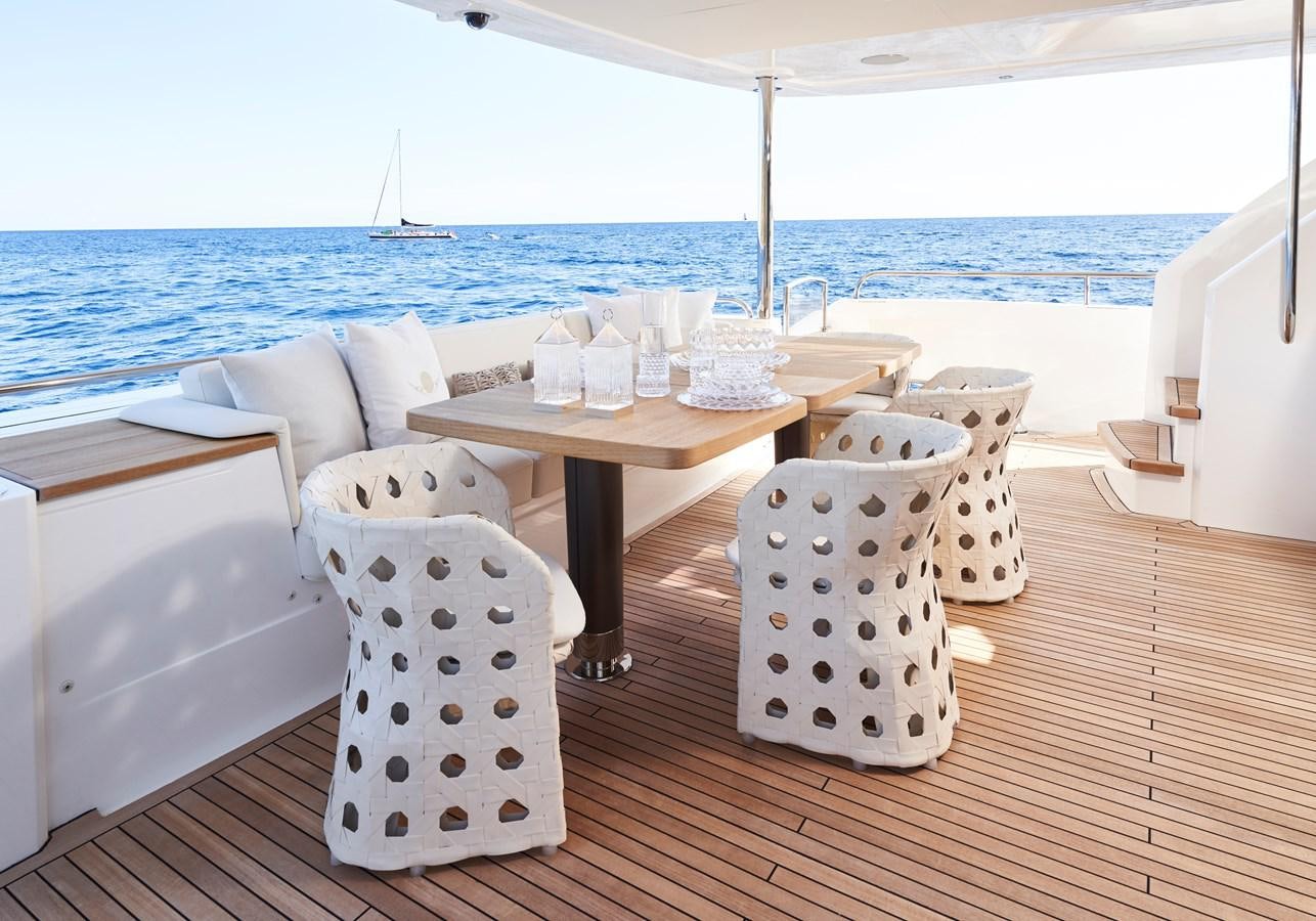 a table and chairs on a deck aboard NADIRA Yacht for Sale