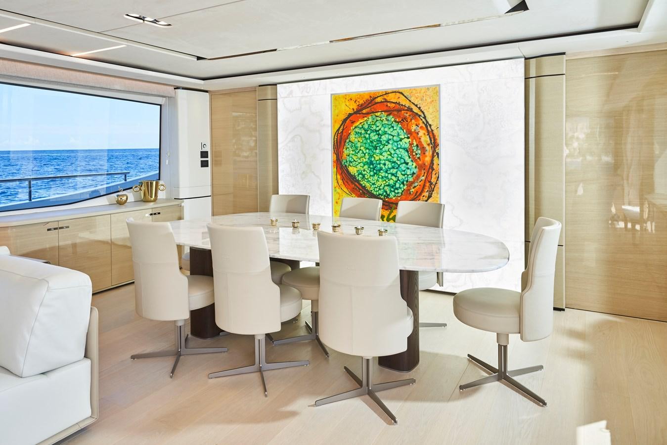 a room with white chairs and a large map on the wall aboard NADIRA Yacht for Sale