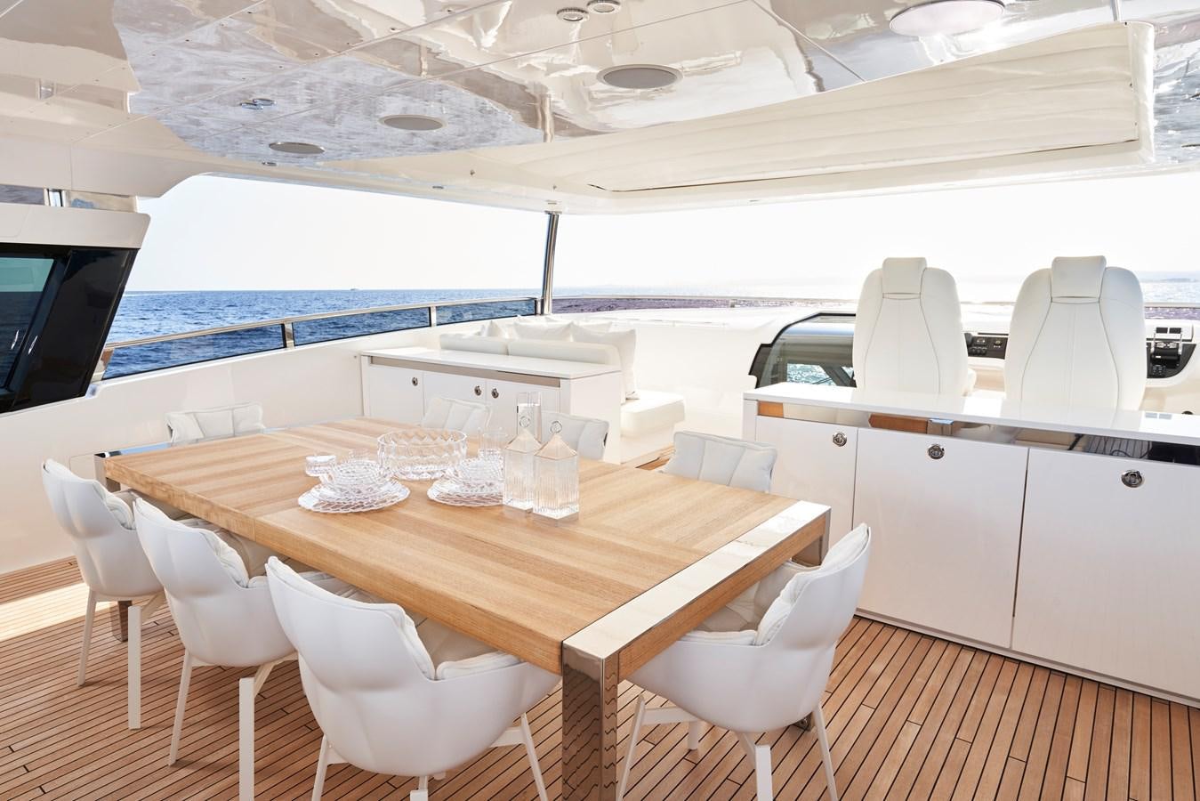 a table with chairs and a white table with white chairs aboard NADIRA Yacht for Sale