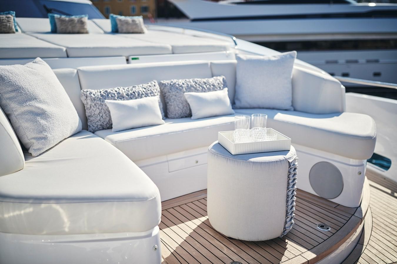 a white couch with pillows aboard NADIRA Yacht for Sale