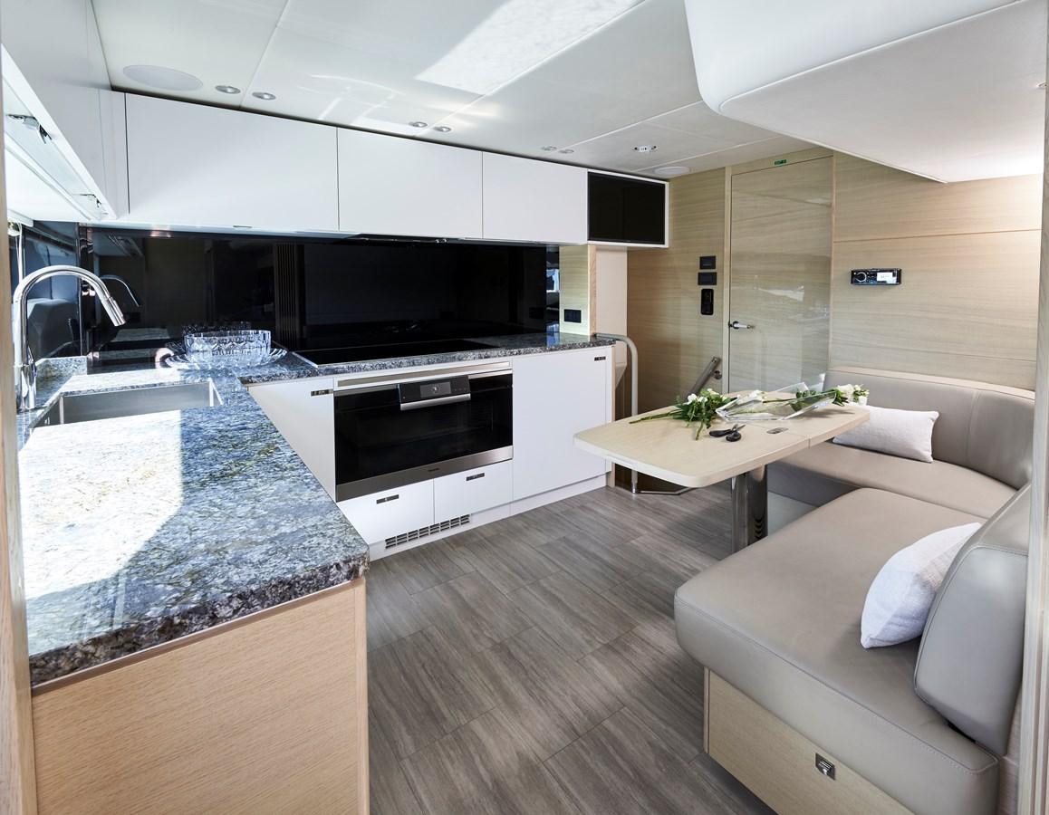 a modern looking kitchen with a large island aboard NADIRA Yacht for Sale