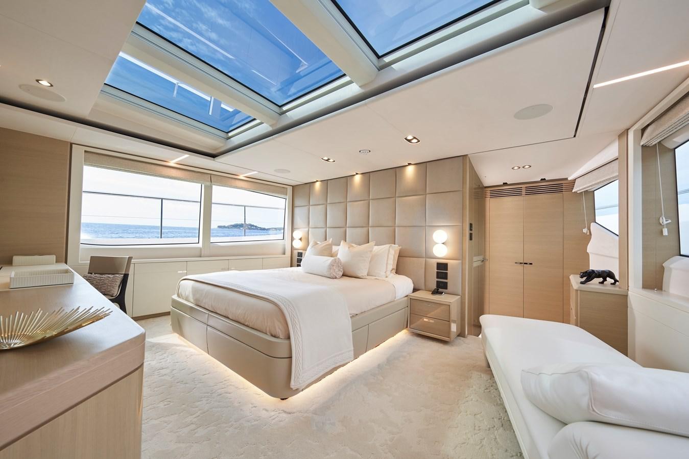 a room with a bed and a desk aboard NADIRA Yacht for Sale