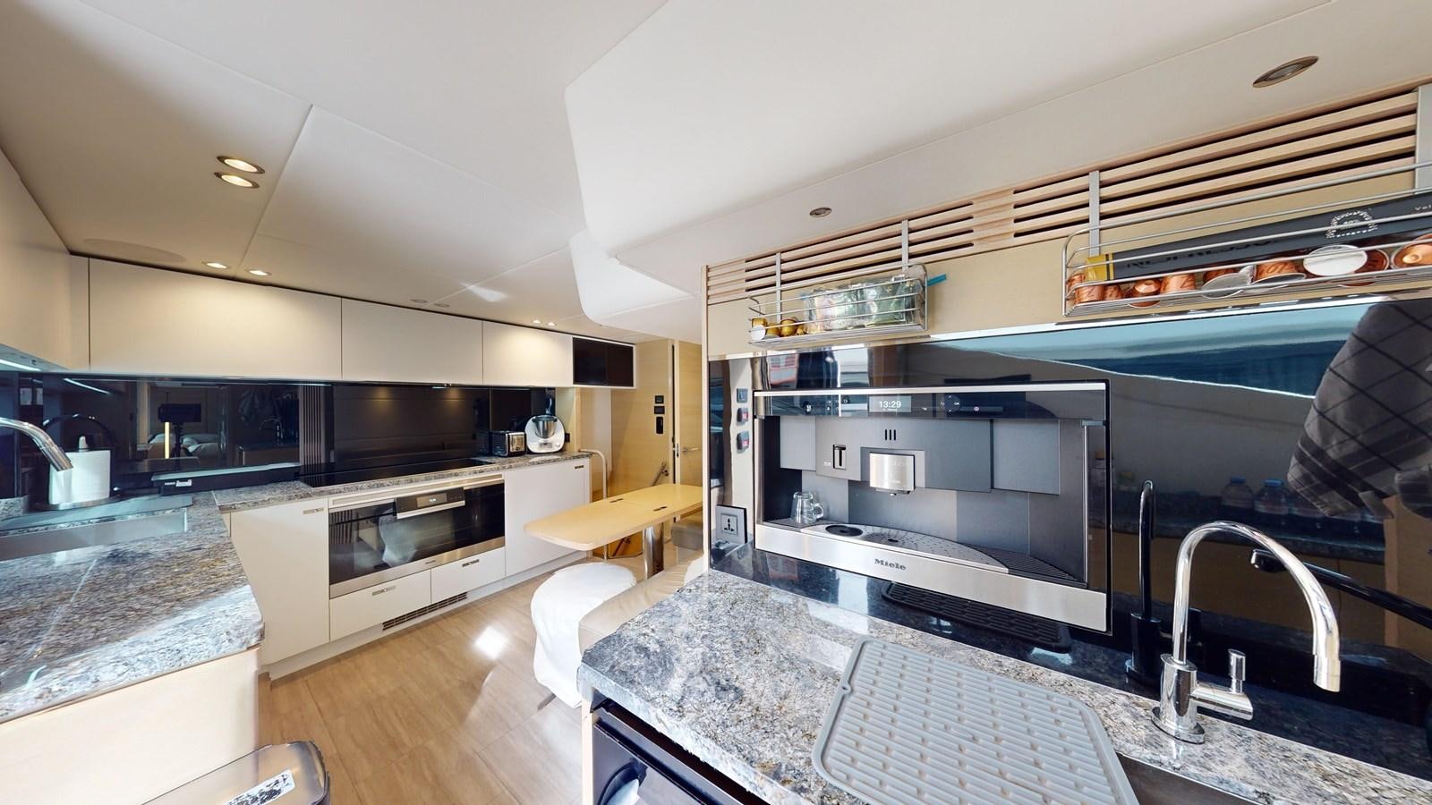 a kitchen with a large island aboard NADIRA Yacht for Sale