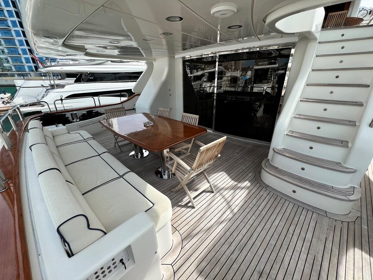 a room with a table chairs and a bed aboard BENETTI 100 Yacht for Sale