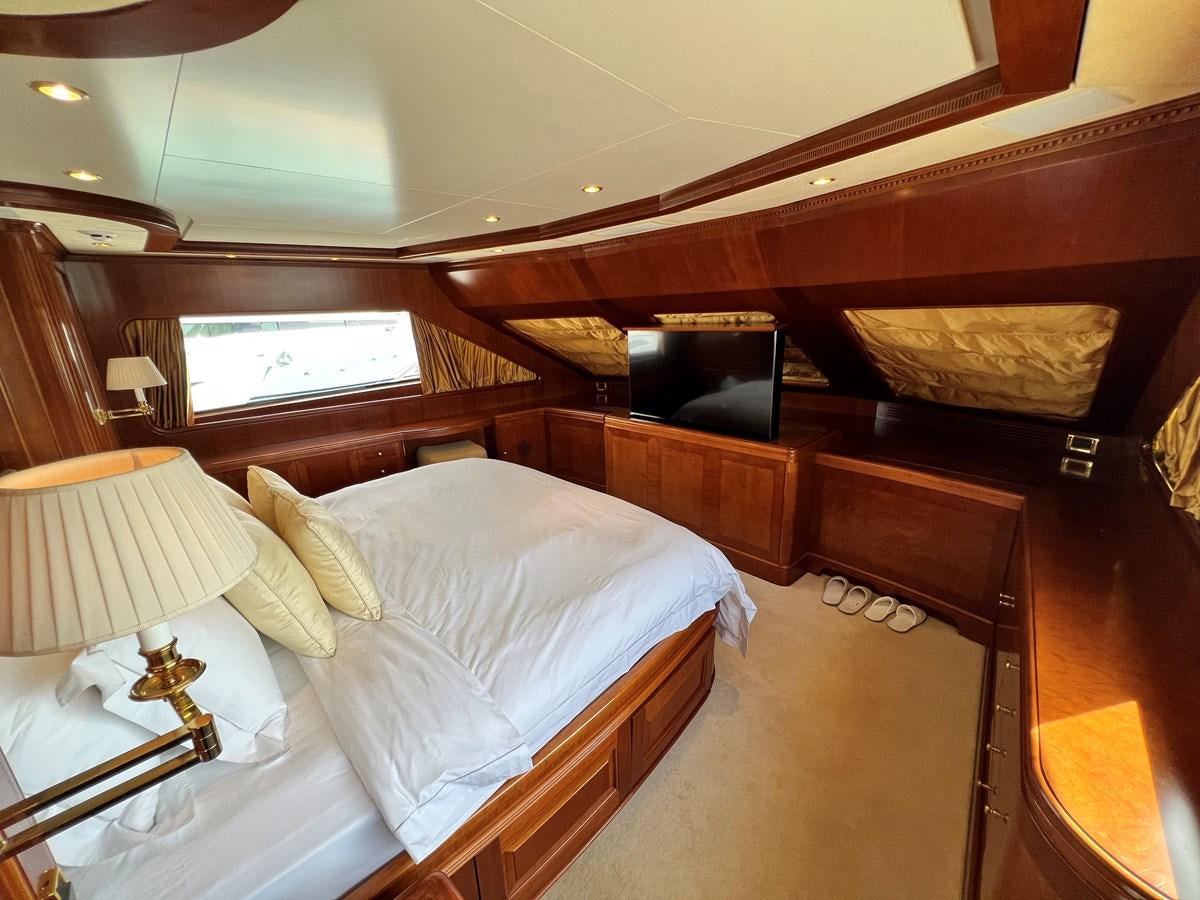 a bedroom with a bed and a television aboard BENETTI 100 Yacht for Sale