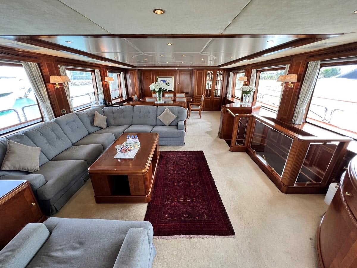 a living room with a couch and a piano aboard BENETTI 100 Yacht for Sale