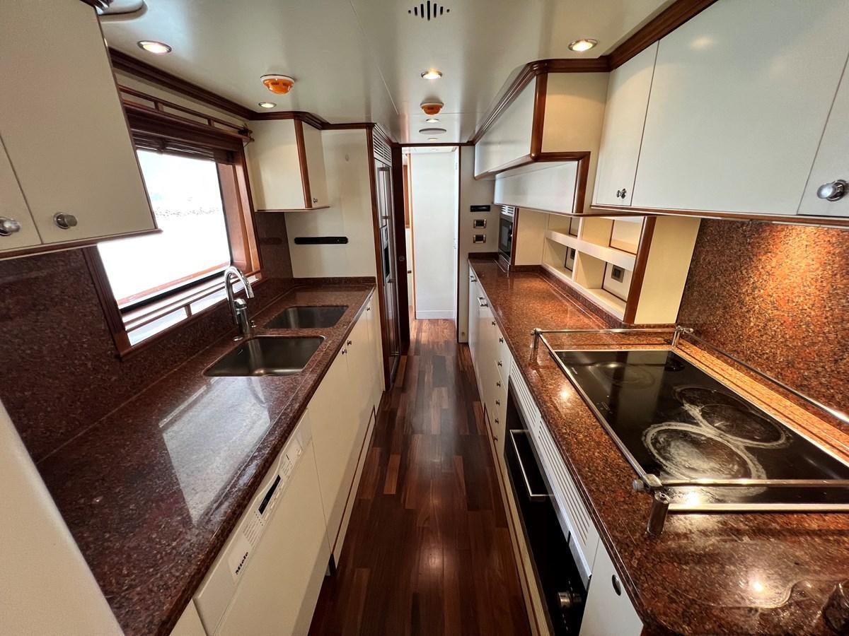 a kitchen with a large island aboard BENETTI 100 Yacht for Sale