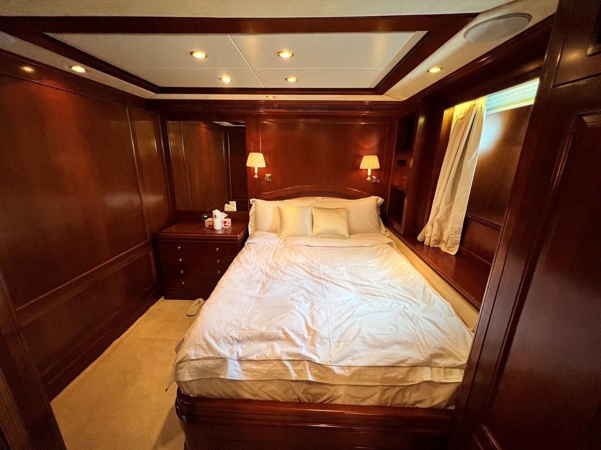 a bed in a room aboard BENETTI 100 Yacht for Sale