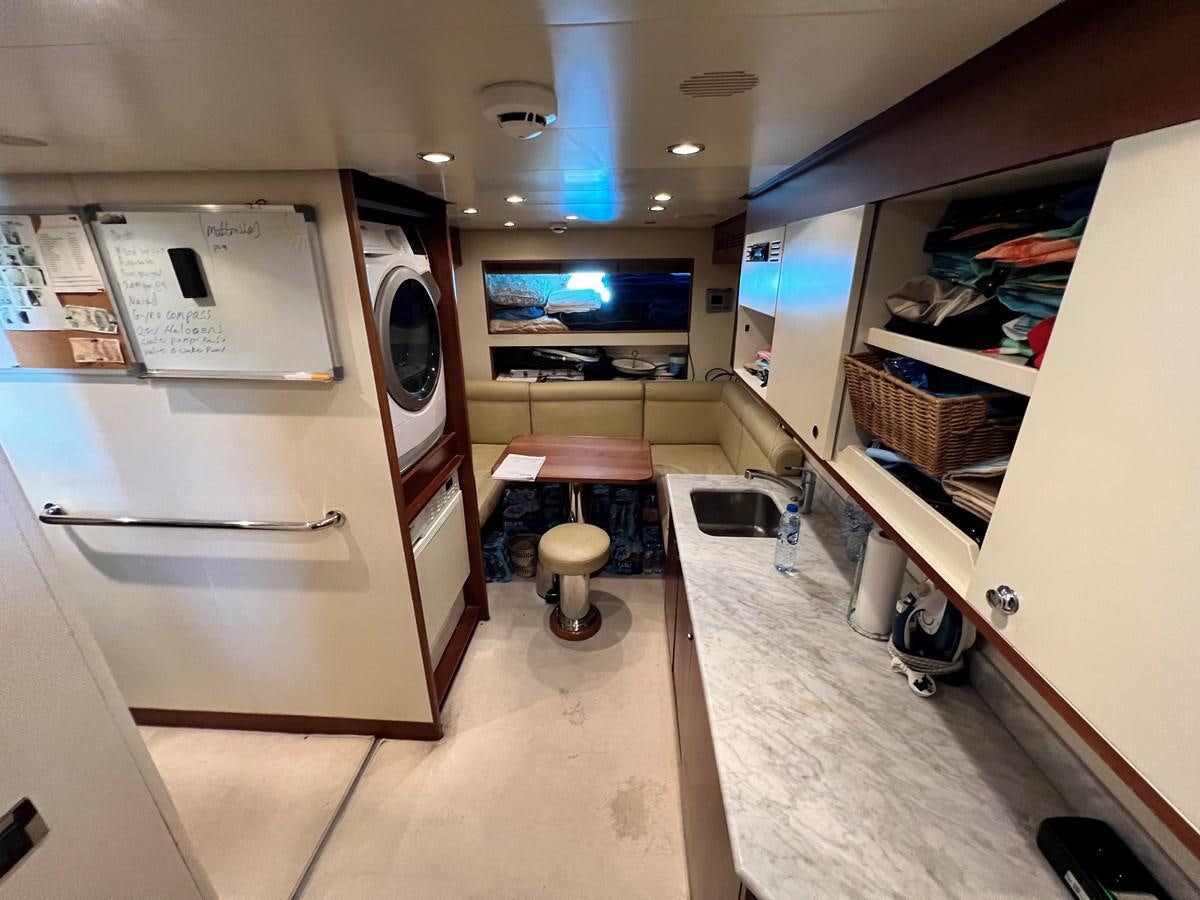 a room with a table and chairs aboard BENETTI 100 Yacht for Sale