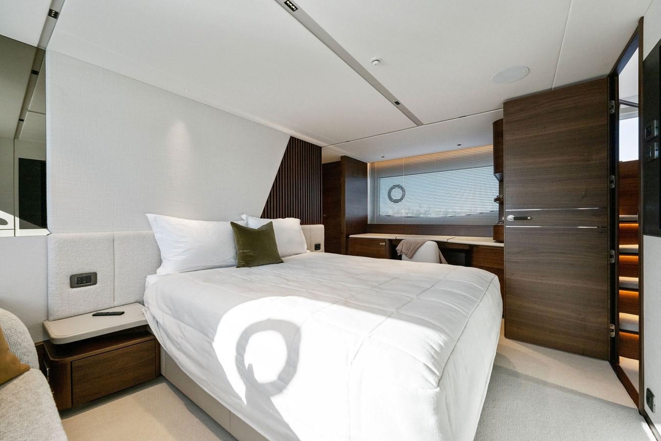 a room with a bed and a wood cabinet aboard ELIZABETH Yacht for Sale