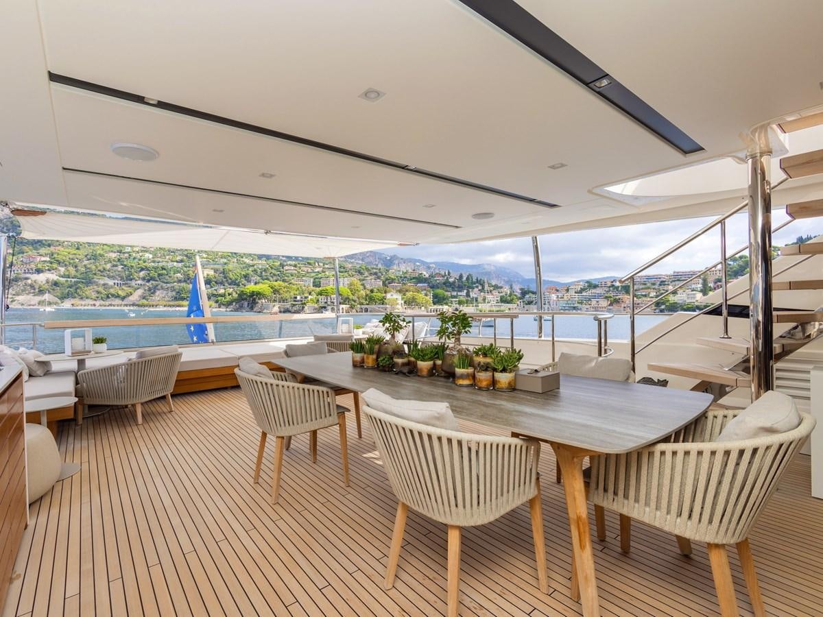 a room with tables and chairs aboard MOCEAN II Yacht for Sale