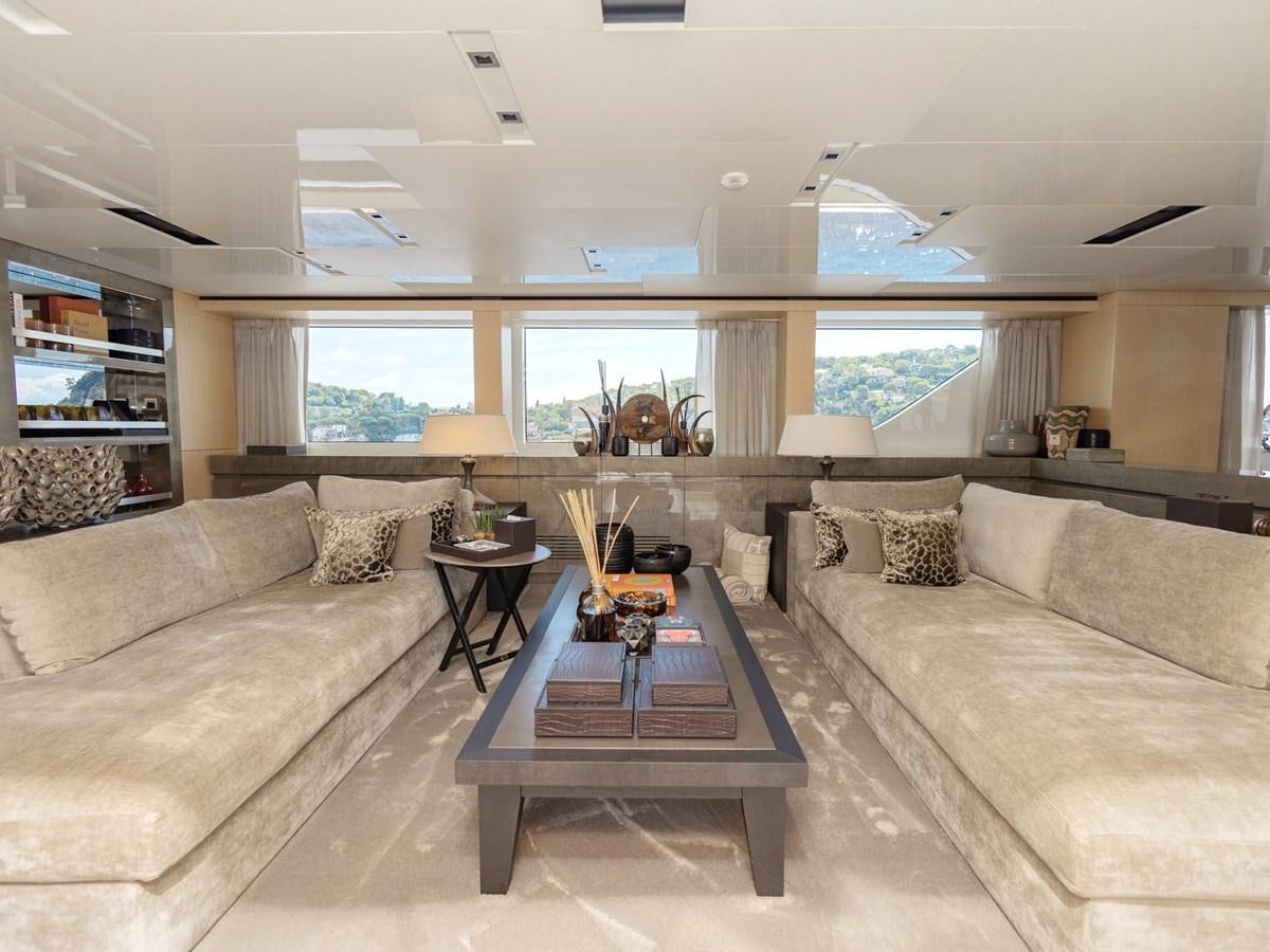 a living room with a couch and a coffee table aboard MOCEAN II Yacht for Sale