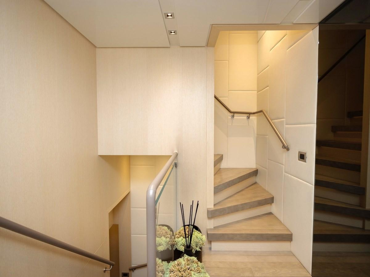 a white staircase with a potted plant in a house aboard MOCEAN II Yacht for Sale