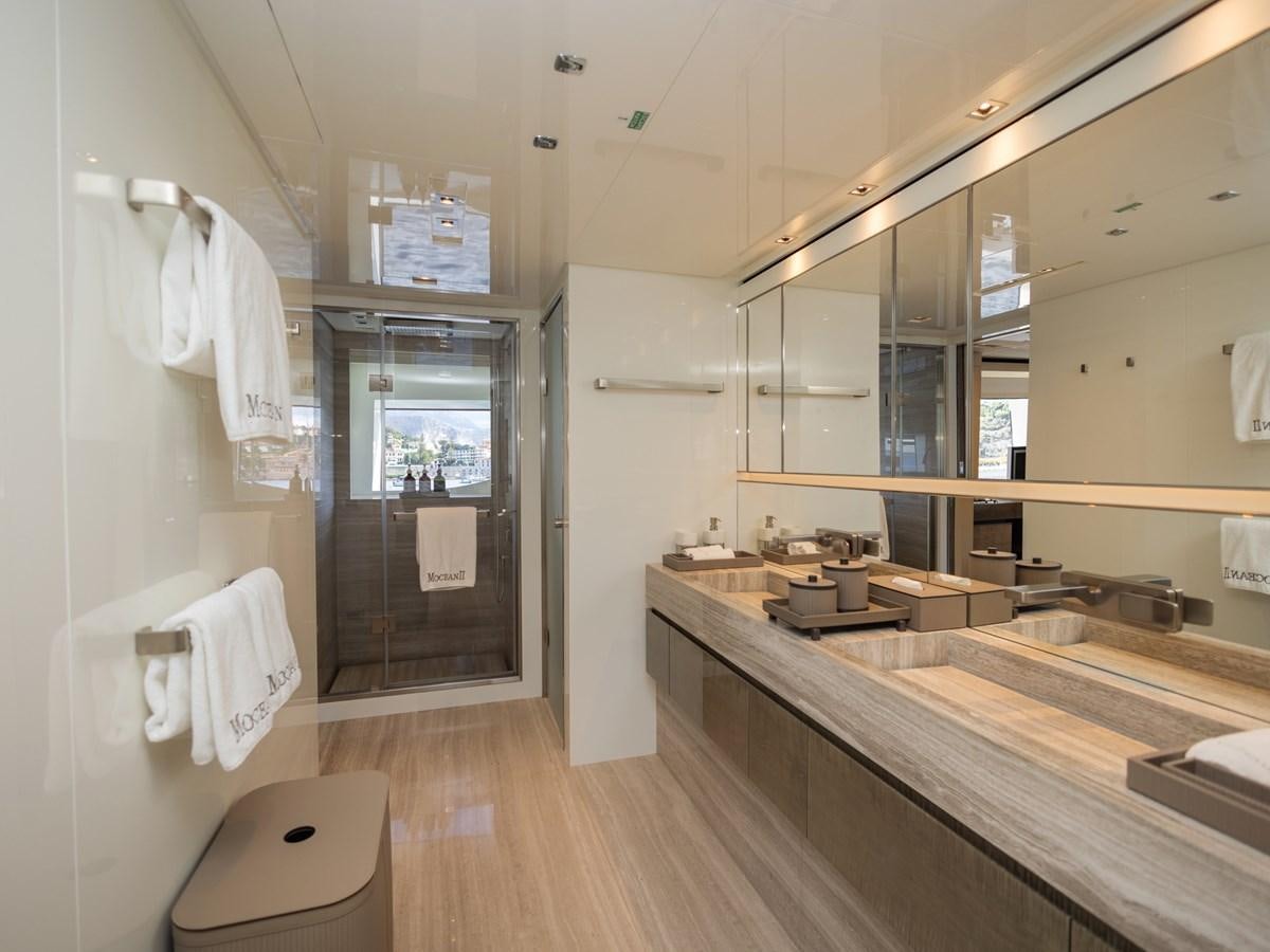 a bathroom with a countertop sink and a mirror aboard MOCEAN II Yacht for Sale