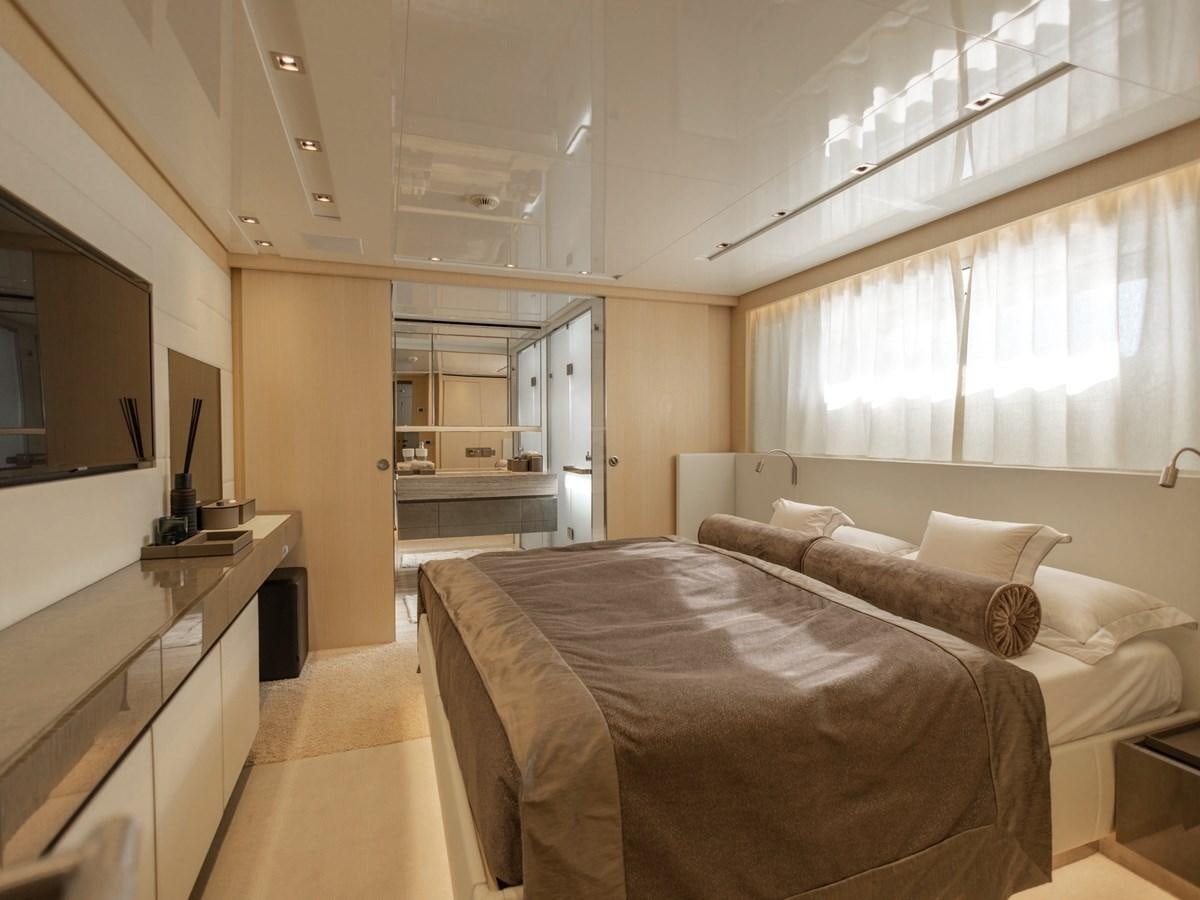 a bedroom with a bed and a tv aboard MOCEAN II Yacht for Sale