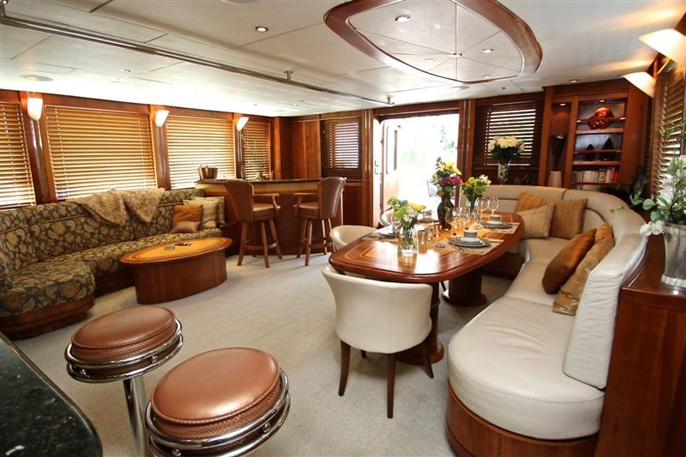 a living room with a couch and a table aboard IMPETUS Yacht for Sale