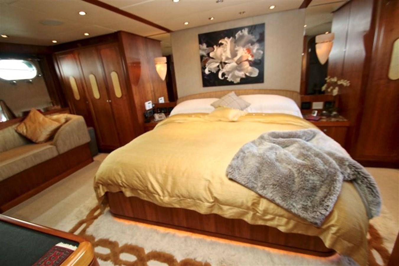 a bedroom with a bed and a couch aboard IMPETUS Yacht for Sale