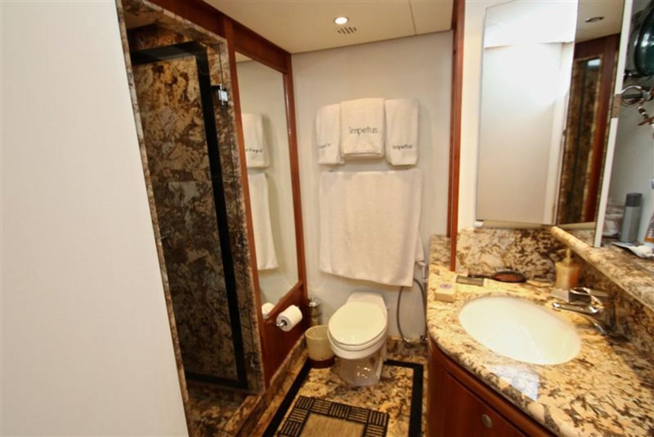 a bathroom with a sink and toilet aboard IMPETUS Yacht for Sale