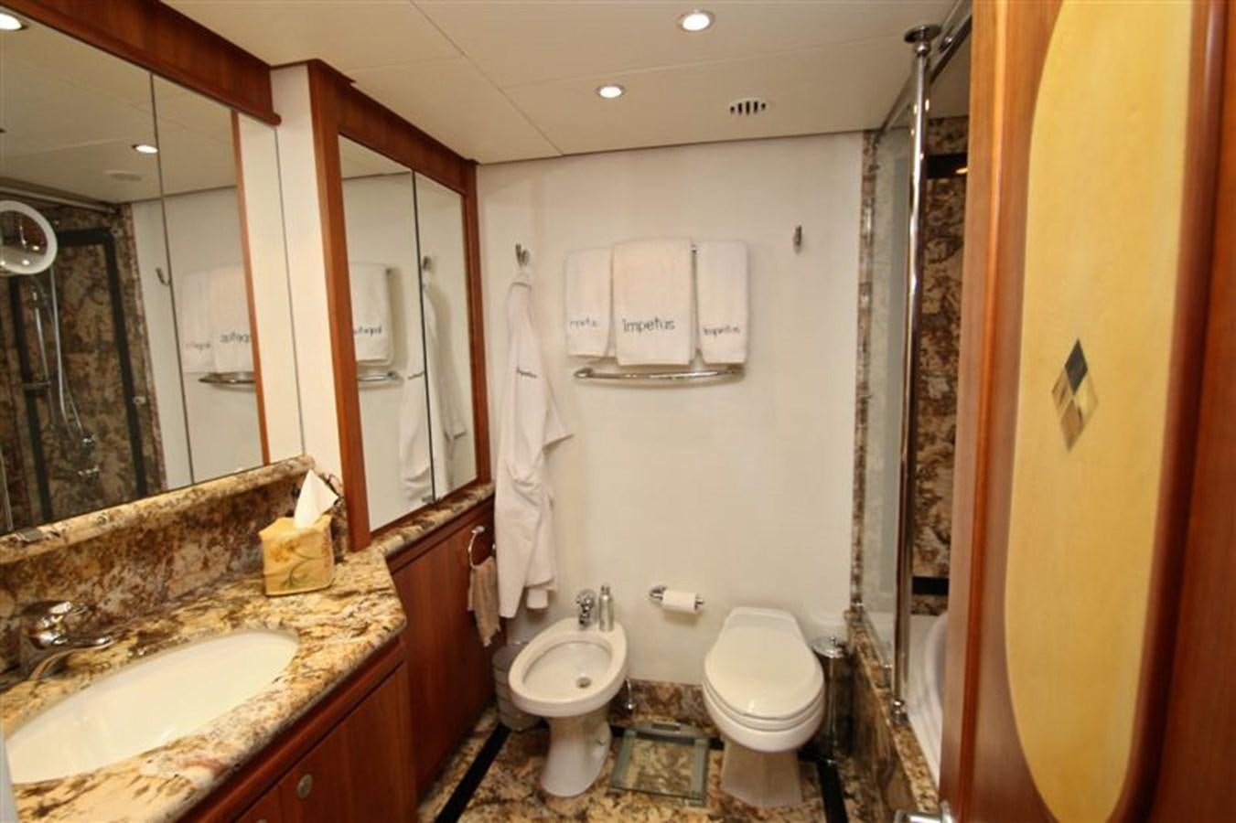 a bathroom with a sink toilet and a mirror aboard IMPETUS Yacht for Sale