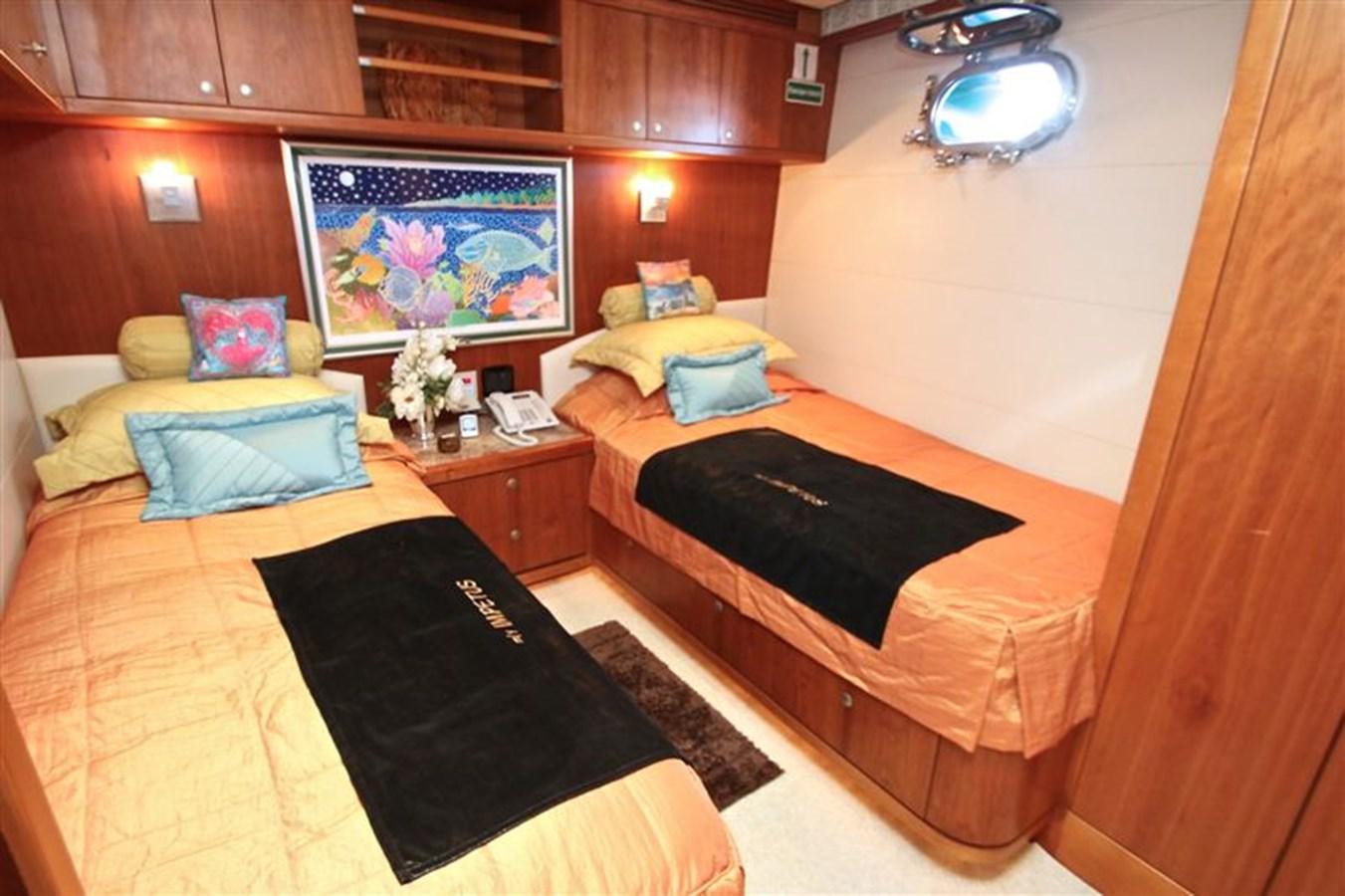 a room with a bed and a mirror aboard IMPETUS Yacht for Sale