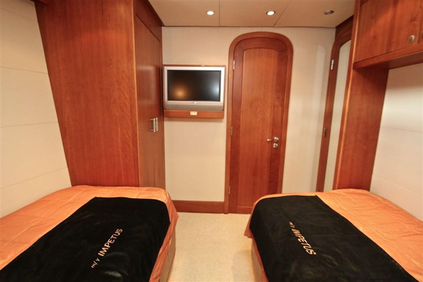 a room with a tv and a bed aboard IMPETUS Yacht for Sale
