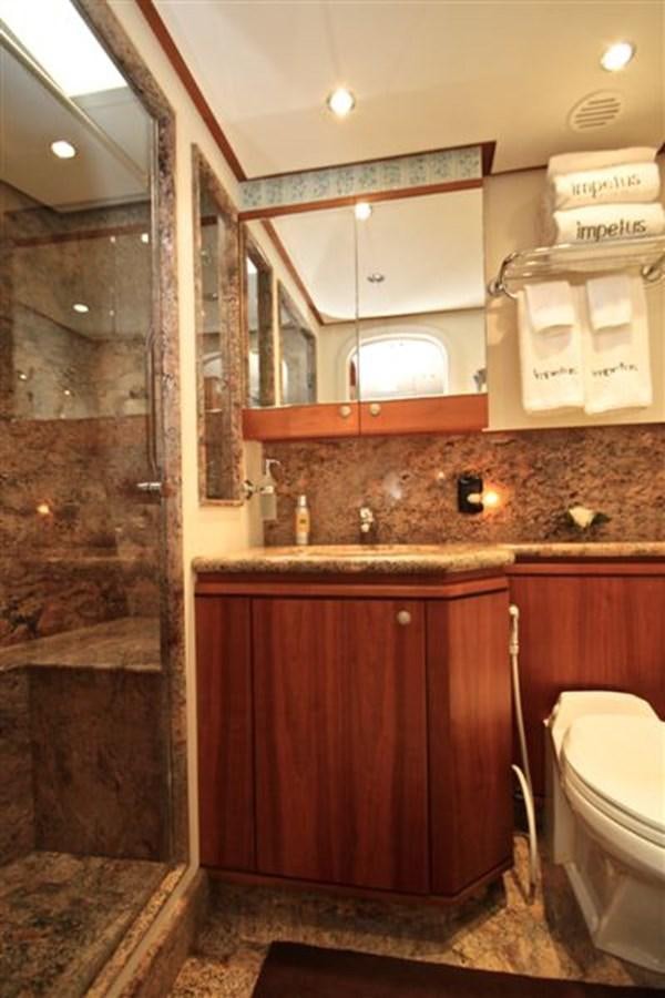 a bathroom with a glass shower aboard IMPETUS Yacht for Sale