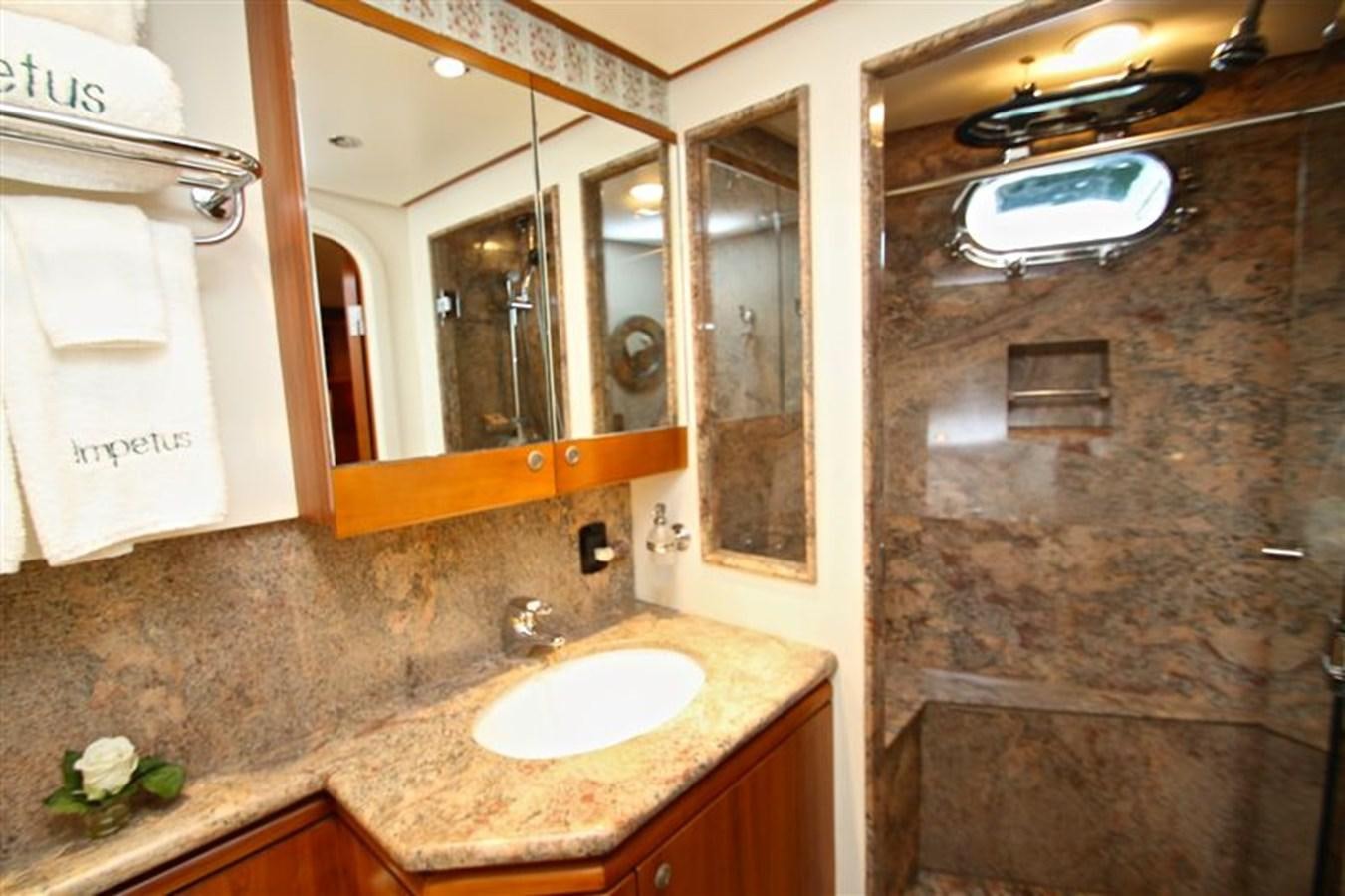 a bathroom with a marble counter top aboard IMPETUS Yacht for Sale