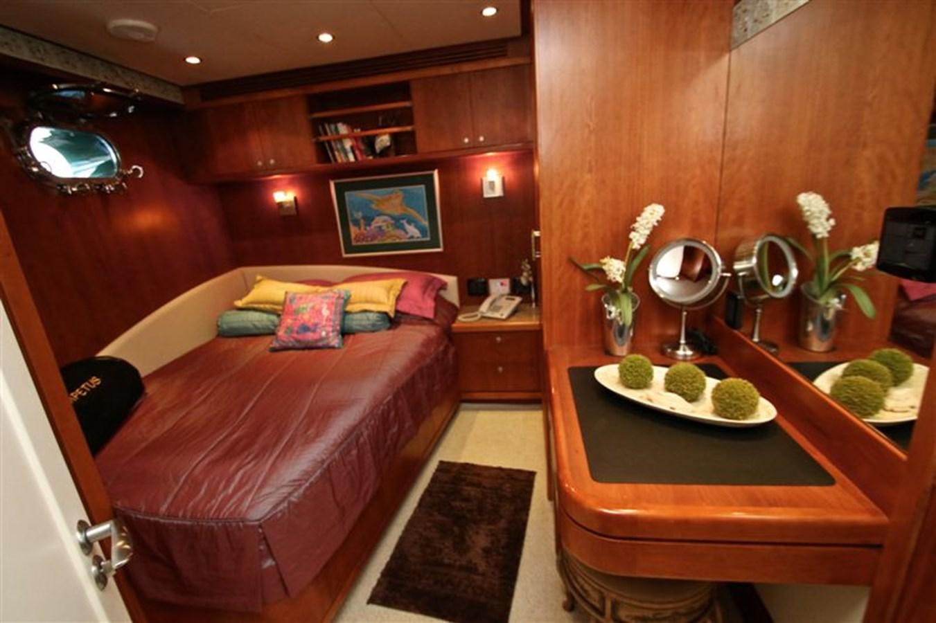 a bed room with a table aboard IMPETUS Yacht for Sale