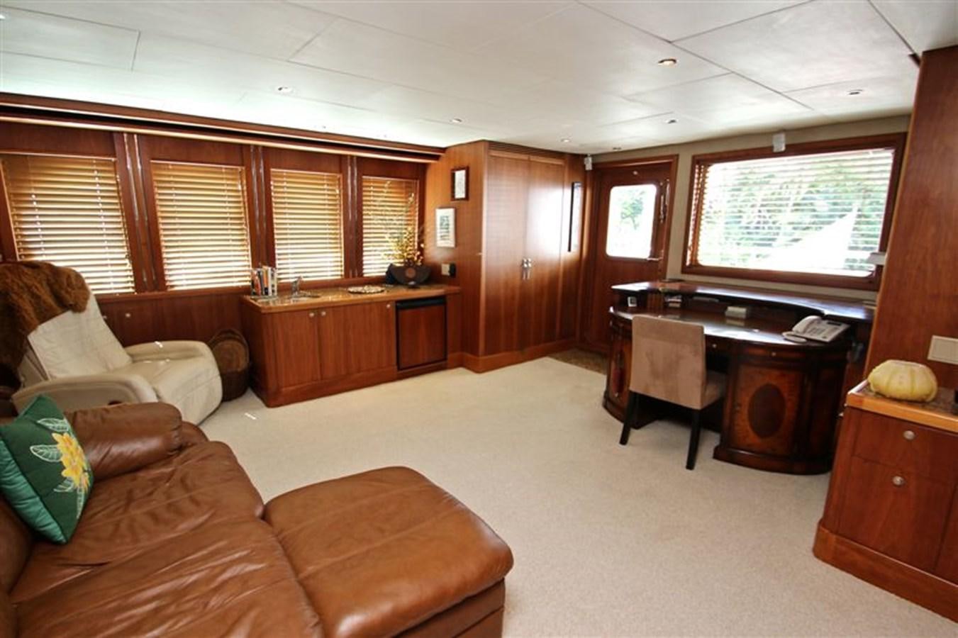 a living room with a piano aboard IMPETUS Yacht for Sale