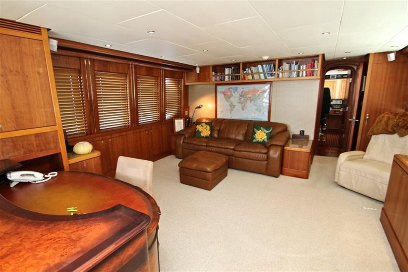 a living room with a leather couch aboard IMPETUS Yacht for Sale