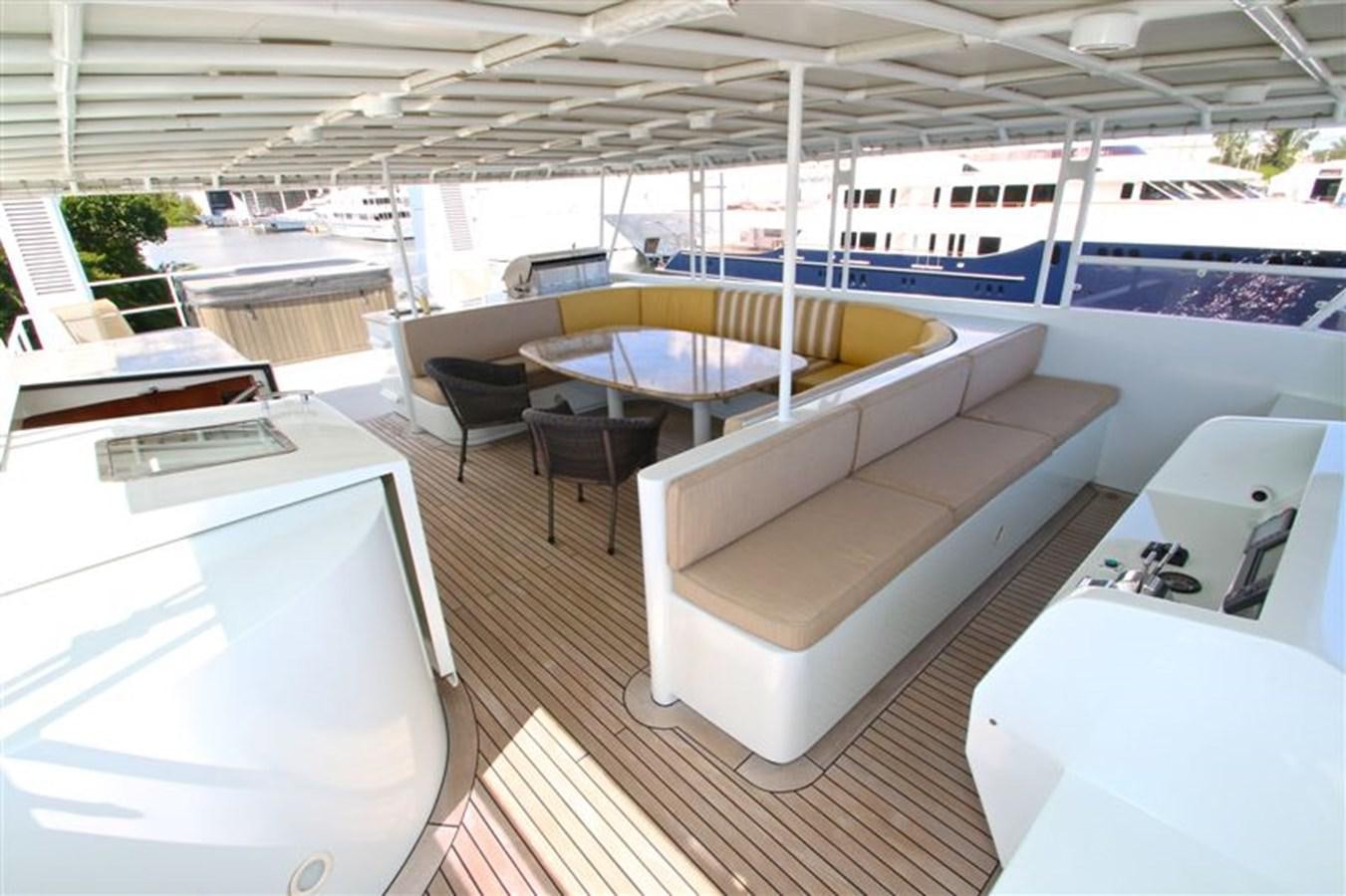 a room with a table chairs and a pool aboard IMPETUS Yacht for Sale