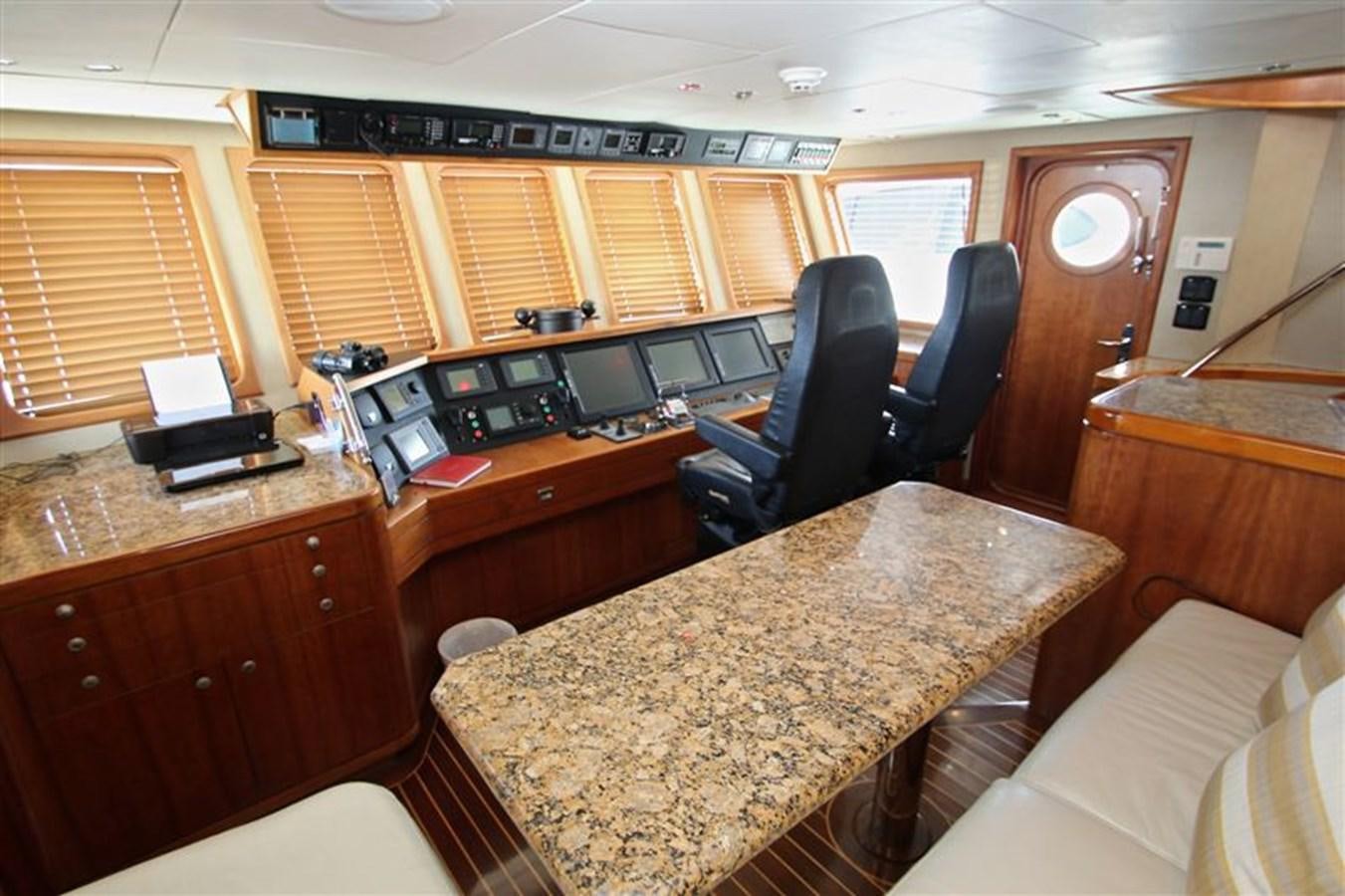 a room with a table and chairs aboard IMPETUS Yacht for Sale