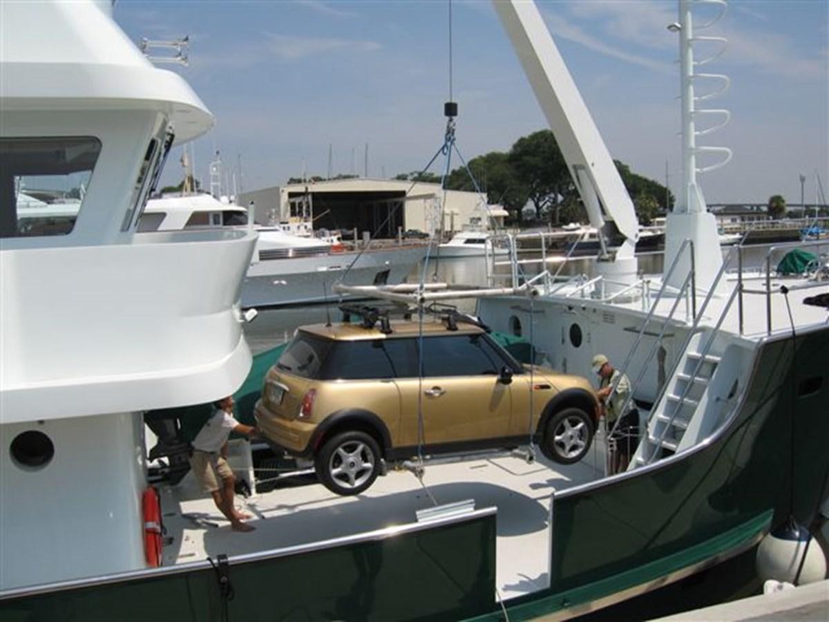 a car parked next to a boat aboard IMPETUS Yacht for Sale