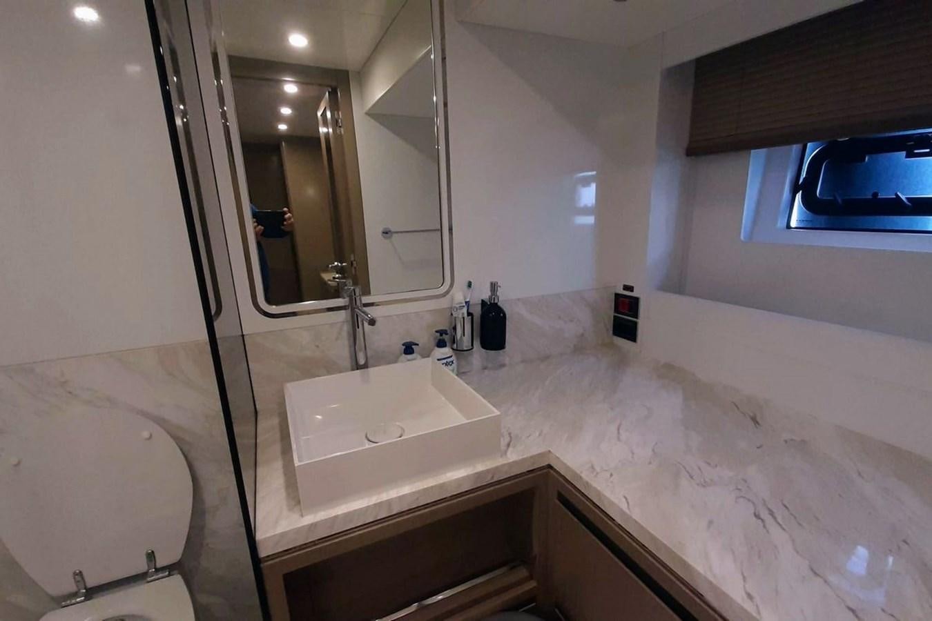 a bathroom with a sink and a mirror aboard SIRENA 68 Yacht for Sale