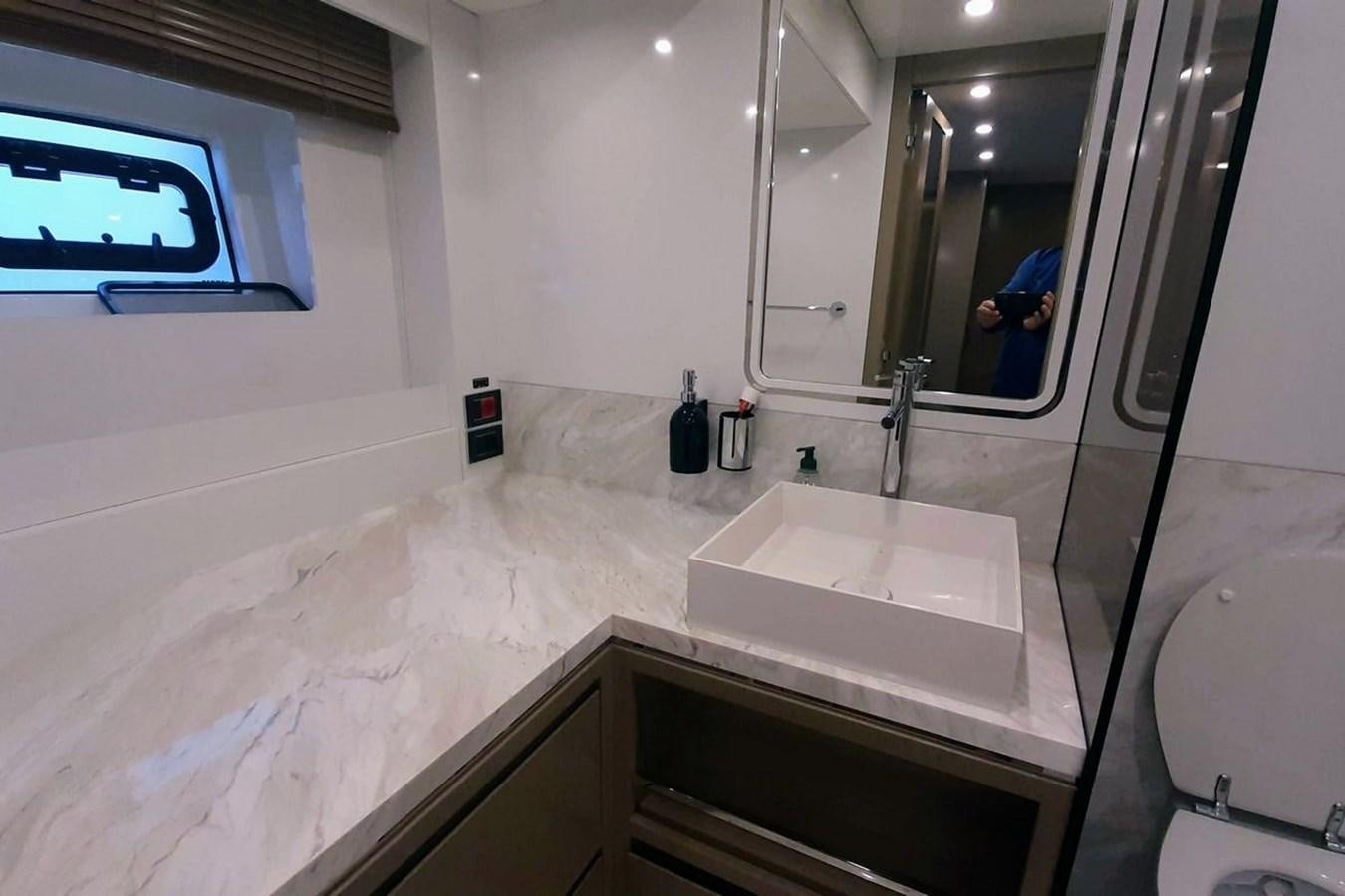 a bathroom with a sink and a mirror aboard SIRENA 68 Yacht for Sale