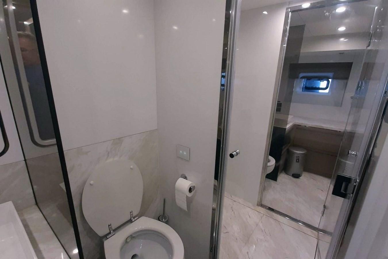 a bathroom with a glass shower door aboard SIRENA 68 Yacht for Sale