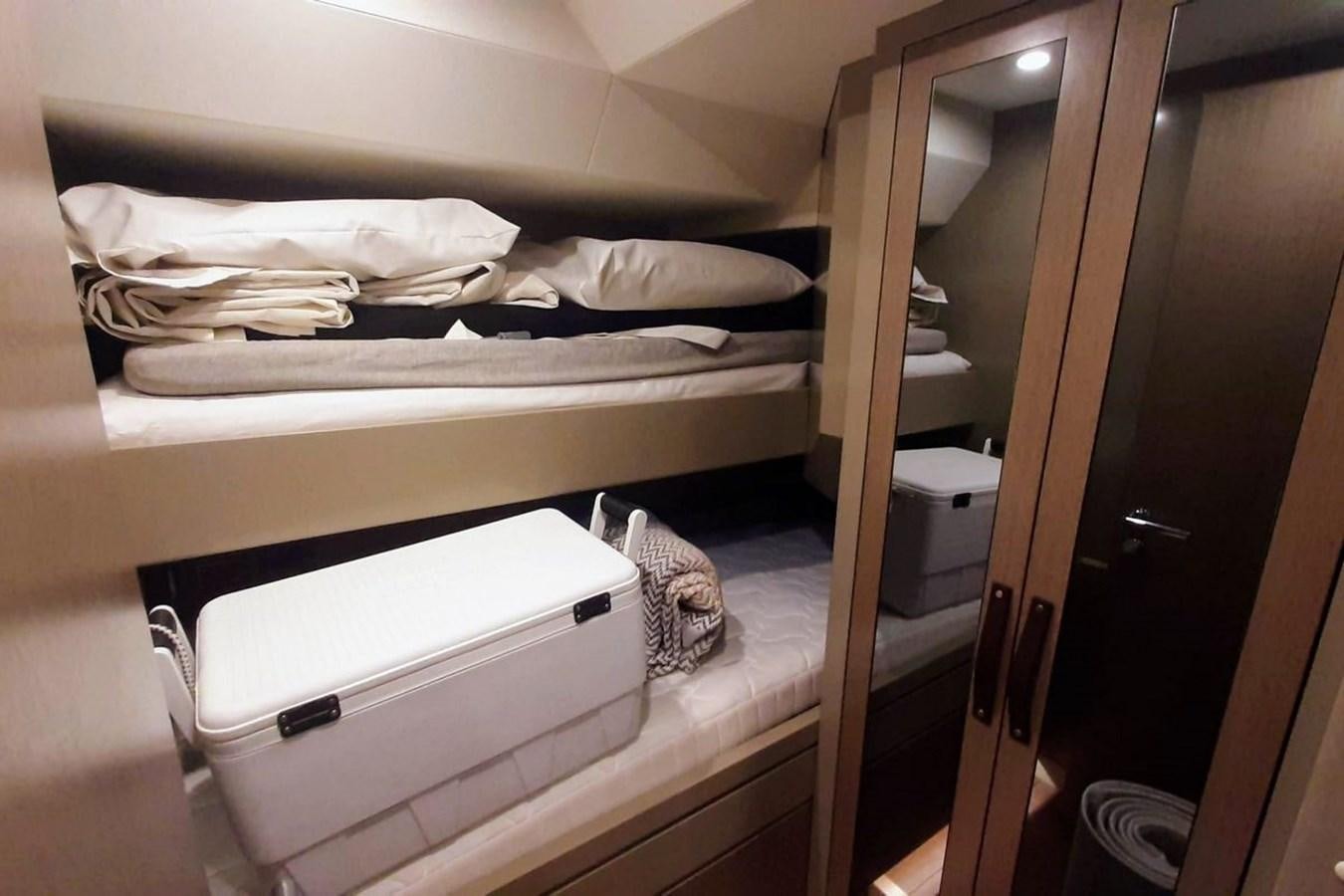 a closet with a bed and a sink aboard SIRENA 68 Yacht for Sale