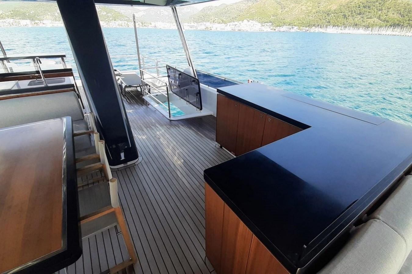 a deck with a large body of water and a deck with chairs aboard SIRENA 68 Yacht for Sale
