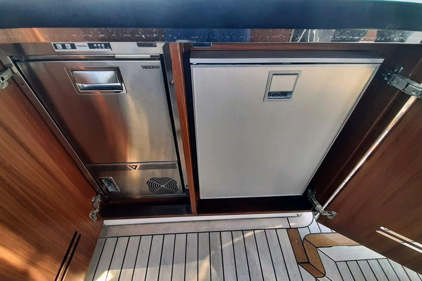 a kitchen with stainless steel appliances aboard SIRENA 68 Yacht for Sale