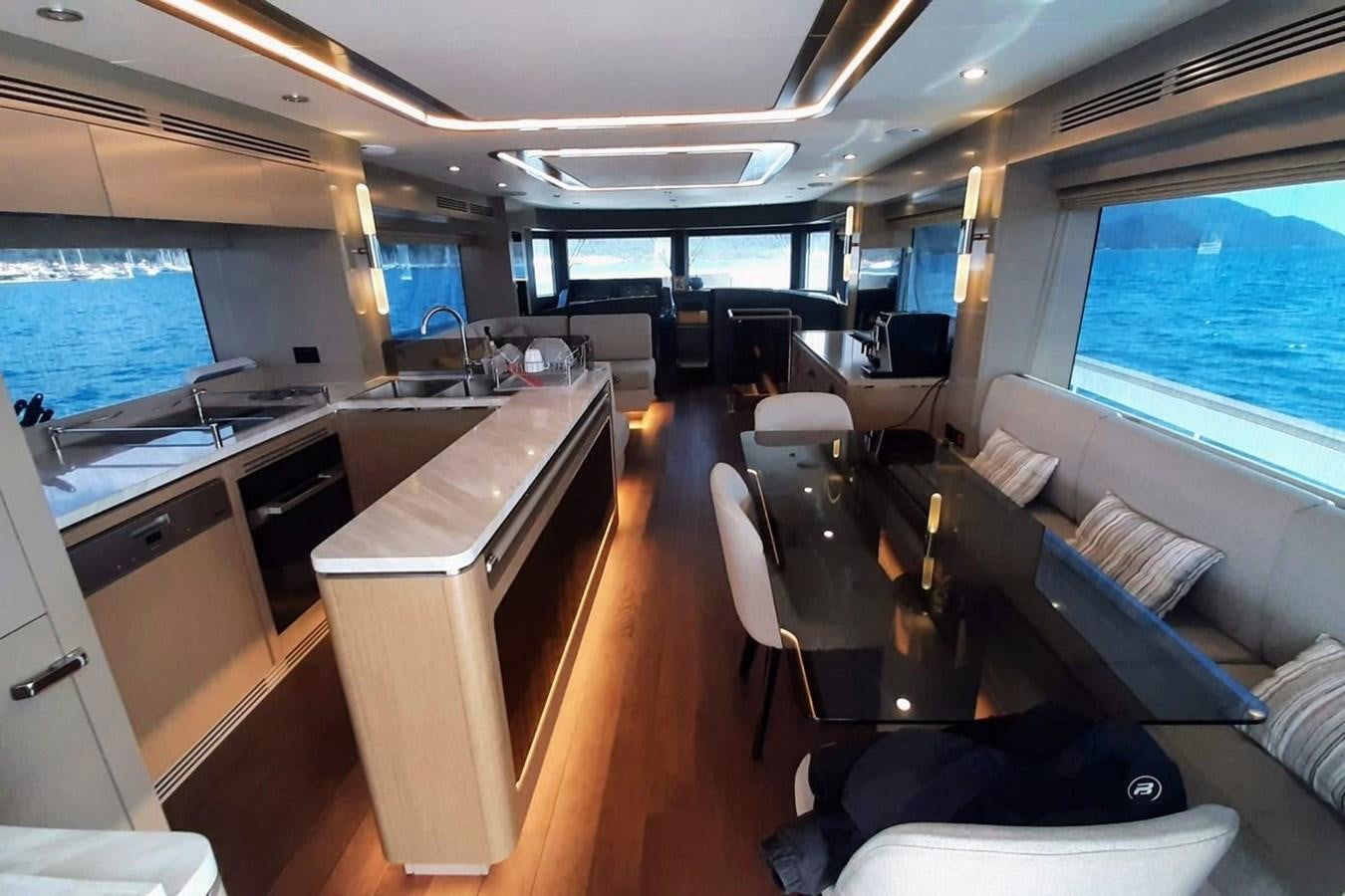 a room with a table chairs and a large window aboard SIRENA 68 Yacht for Sale