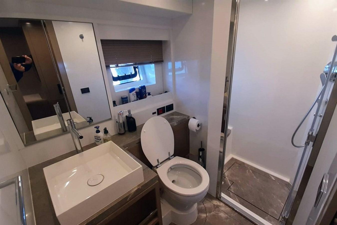 a bathroom with a sink toilet and a bathtub aboard SIRENA 68 Yacht for Sale